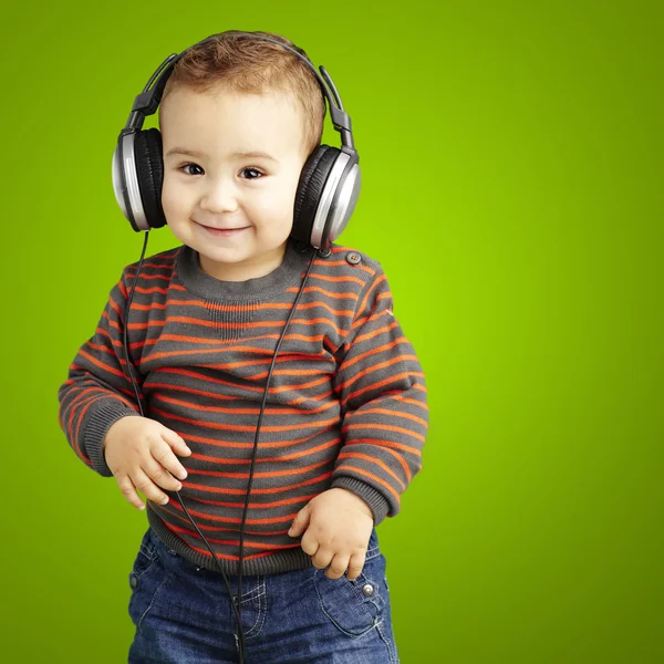 Πορτρέτο του ένα όμορφο παιδί ακούγοντας μουσική και χαμογελά πάνω από g — Φωτογραφία Αρχείου