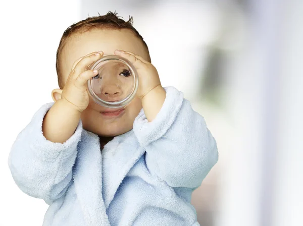Porträtt av bedårande spädbarn med blå badrock dricksvatten i — Stockfoto