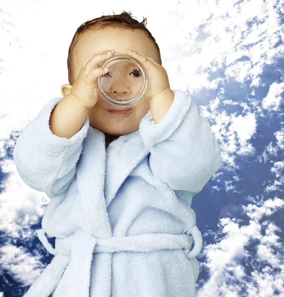 Retrato de bebê adorável com roupão de banho azul água potável em — Fotografia de Stock