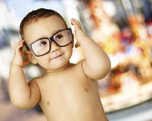 Portret przystojny śmieszne dziecko noszenie okularów przeciw carous — Zdjęcie stockowe