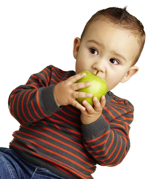 Portrait of a handsome kid bitting a green apple over white back — Stock Photo, Image
