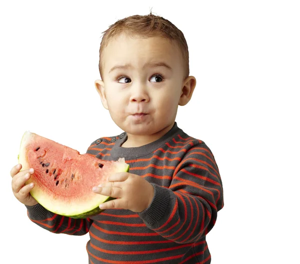 Portret van een knappe jongen houden een watermeloen en proeverij over — Stockfoto