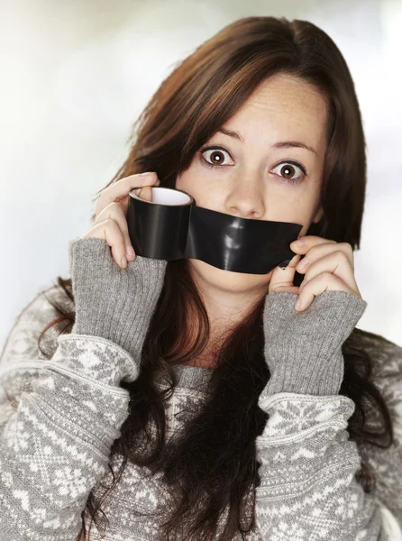 Portrait of scared girl being silenced by herself over black bac — Stock Photo, Image
