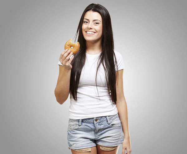 Женщина с пончиком в руках — стоковое фото