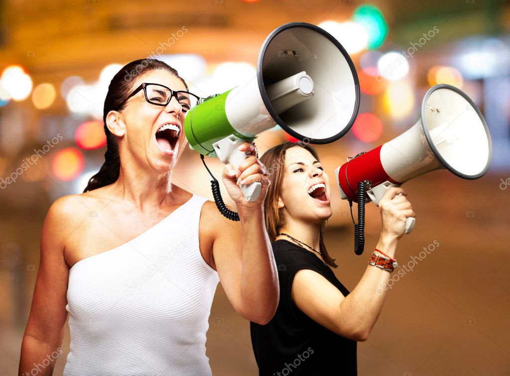 shouting with megaphone at city by night