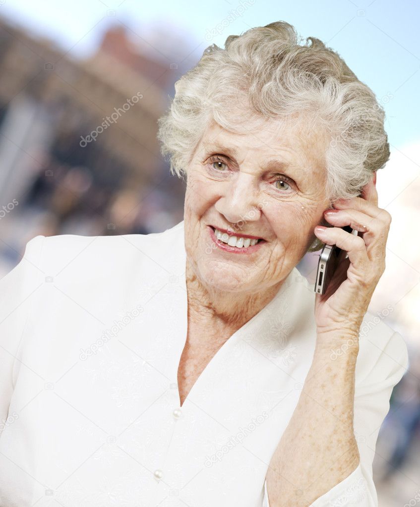 Portrait of senior woman talking on mobile at city