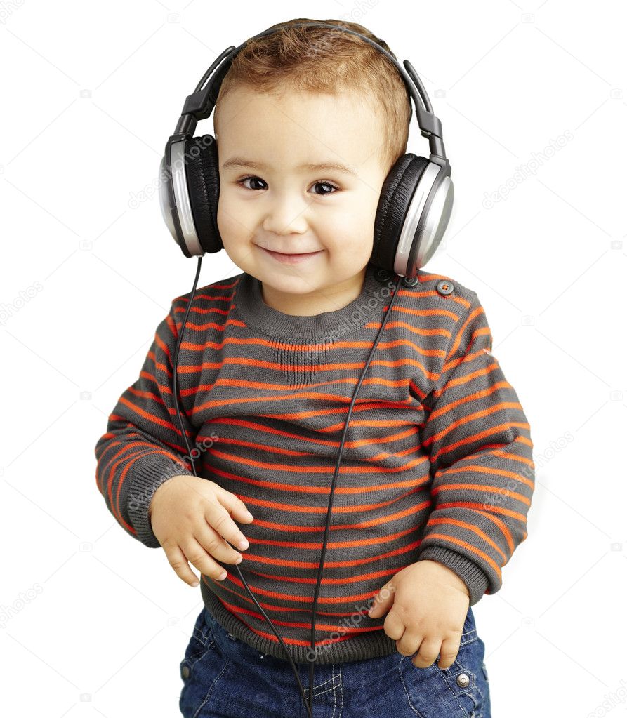 Portrait of a handsome kid listening to music and smiling over w