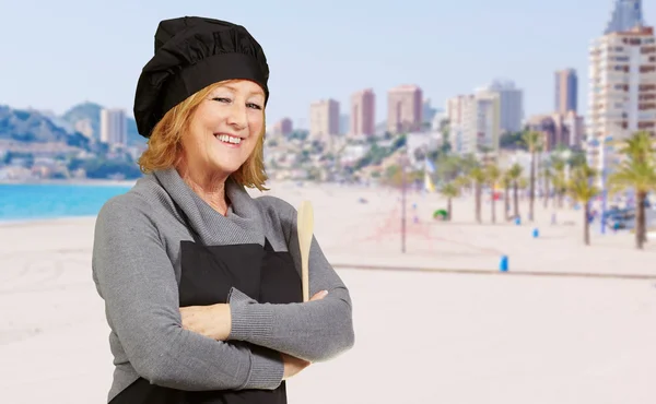 Portrait of cook middle aged woman smiling near the beach — Stock Photo, Image