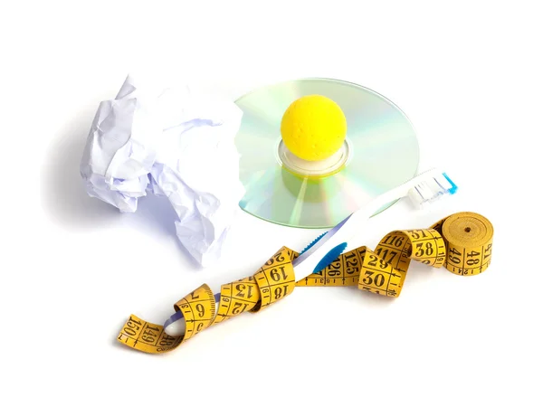 Disk,centimeter,toothbrush, yellow ball, paper — Stock Photo, Image