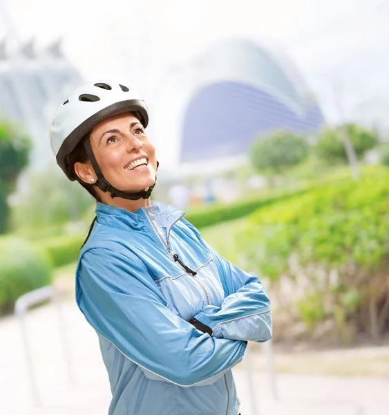 Portrait of a sporty middle aged woman wearing a bicycle helmet — Stock Photo, Image