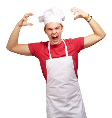 Portrait of young cook man wearing apron doing aggressive gestur clipart