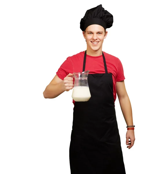 Portret młodej gotować człowieka posiadającego mleka słoik na biały deseń — Zdjęcie stockowe