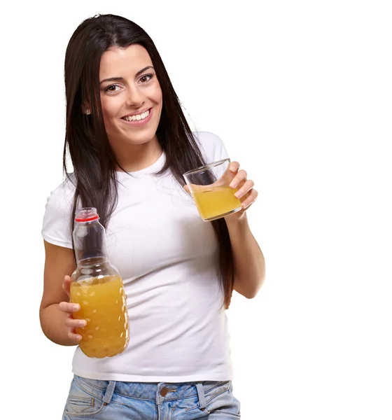 Portrait of young girl drinking orange juice against a white bac — Stock Photo, Image