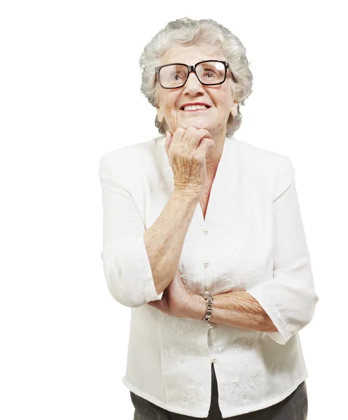 Portrait of senior woman thinking and looking up over white back — Stock Photo, Image