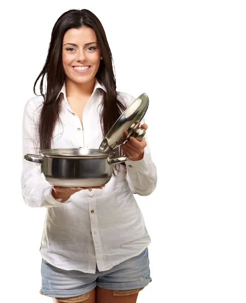Портрет молодої дівчини, що відкриває каструлю соусу на білому тлі — стокове фото