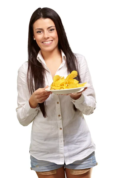 Portrait of young woman holding a potato chips plate over white — Stock Photo, Image