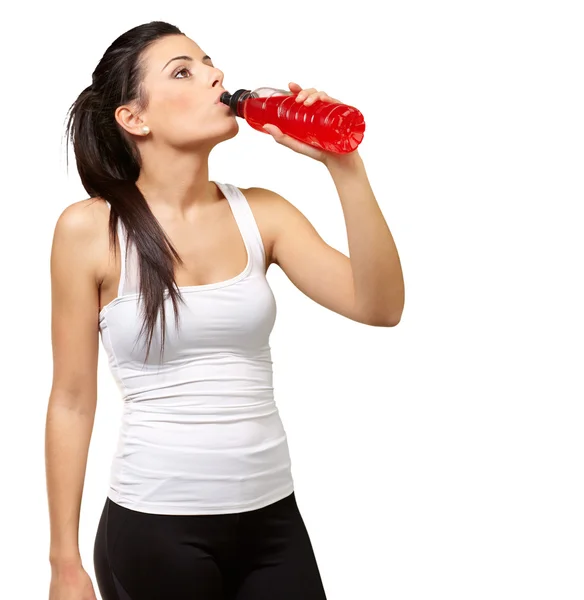 Portrait of young sporty woman drinking isotonic drink over whit — Stock Photo, Image