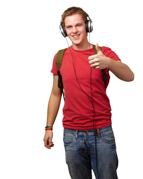 Portrait of cheerful young student listening music and gesturing — Stock Photo, Image