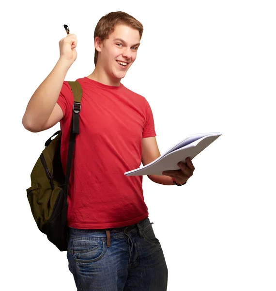 Retrato de estudiante guapo sosteniendo cuaderno y pluma sobre blanco —  Fotos de Stock