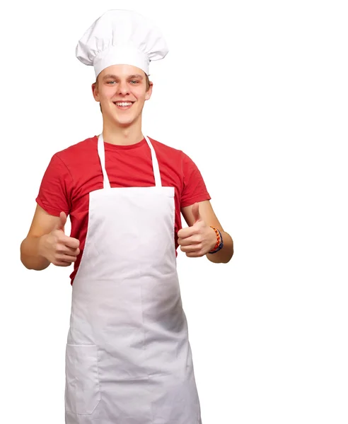 Retrato de jovem cozinheiro fazendo símbolo de sucesso contra um branco — Fotografia de Stock