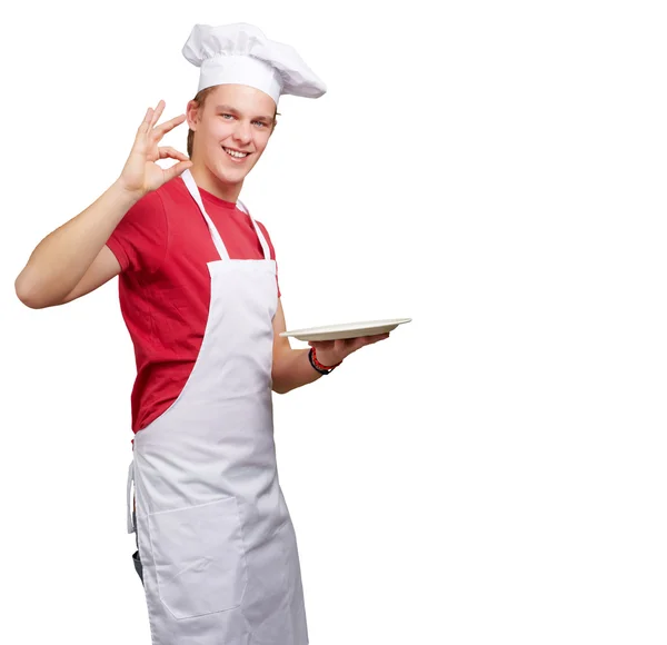 Retrato de jovem cozinheiro homem contra um fundo branco — Fotografia de Stock
