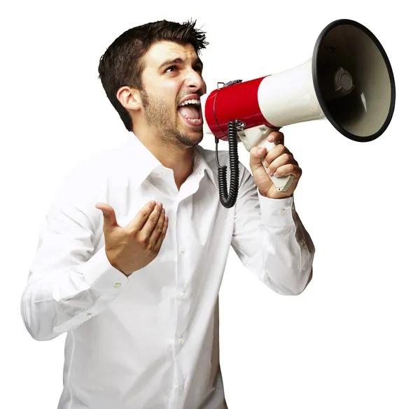 Retrato de un joven gritando con megáfono sobre fondo blanco Imagen de archivo