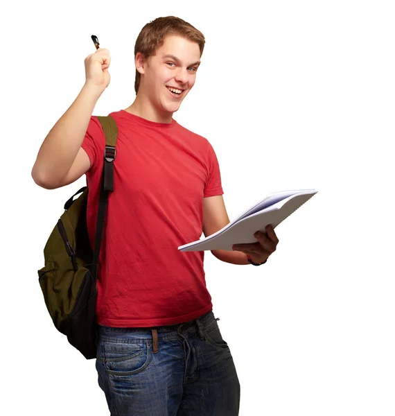 Retrato de estudiante guapo sosteniendo cuaderno y pluma sobre blanco Imagen De Stock