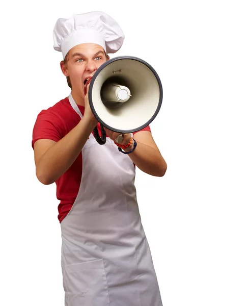 Portrait of young cook man screaming with megaphone over white b Stock Picture