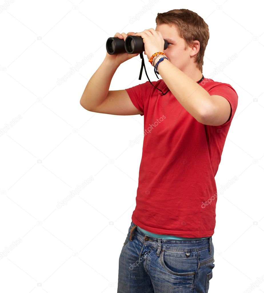 Portrait of young man looking through a binoculars over white ba