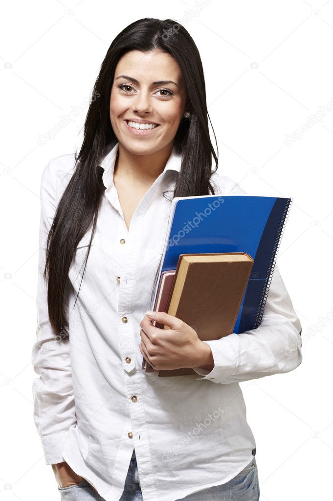 Young student holding books and smiling against a white backgrou