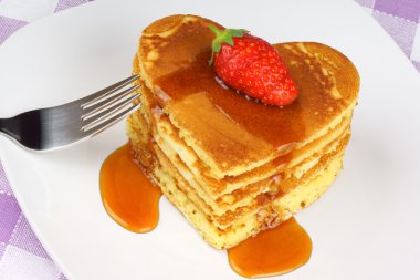 Heart-shaped pancakes with syrup and strawberry clipart