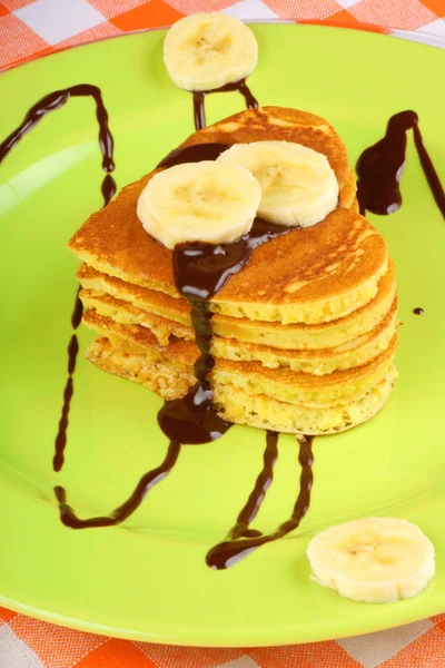 Heart shaped pancakes with chocolate sauce and banana — Stock Photo, Image
