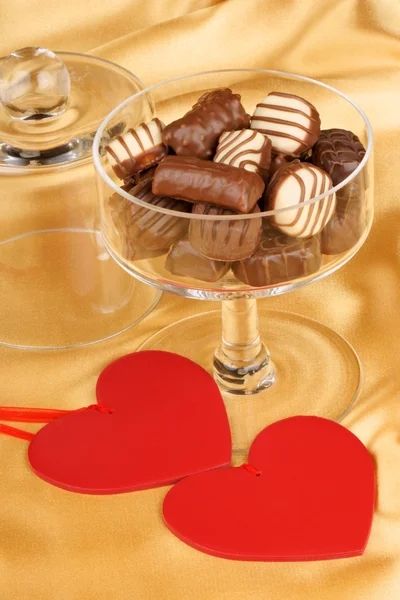 Chocolate pralines and heart shapes — Stock Photo, Image