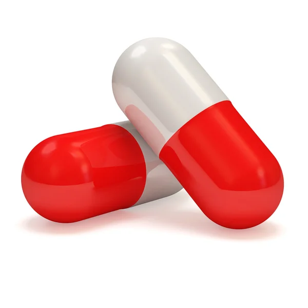 Píldoras rojas sobre fondo blanco —  Fotos de Stock
