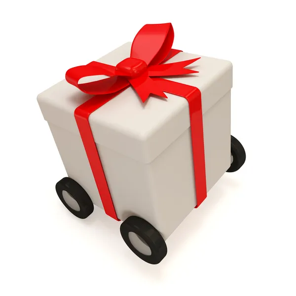 Caixa de presente com fita vermelha sobre rodas isoladas sobre fundo branco — Fotografia de Stock