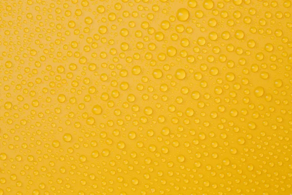 Krople wody na żółty — Zdjęcie stockowe