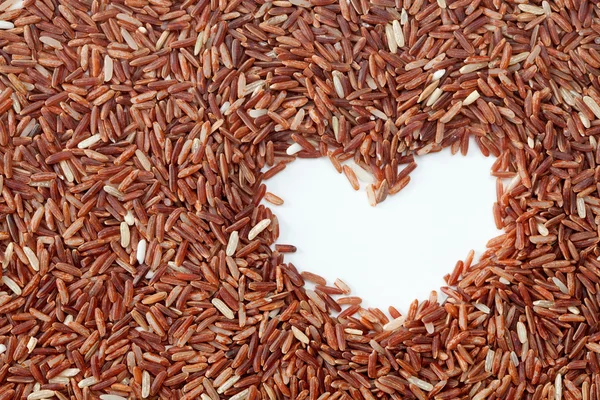 Brown rice with heart shape — Stock Photo, Image