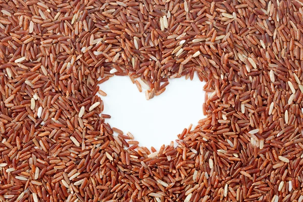 Brown rice with heart shape — Stock Photo, Image