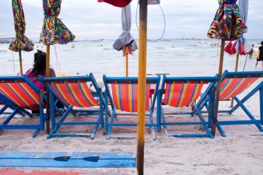 Beach chairs and umbrellas on the beach clipart