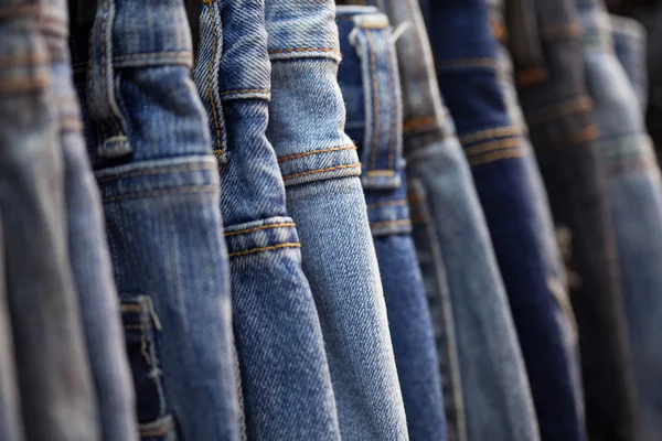 Row of hanged blue jeans — Stock Photo, Image