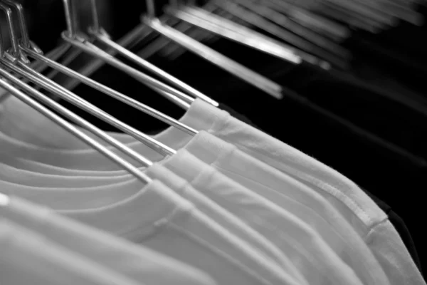 T-shirt bianche su appendini di stoffa in fila — Foto Stock