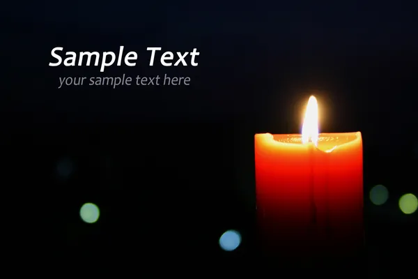 A single burning orange candle — Stock Photo, Image