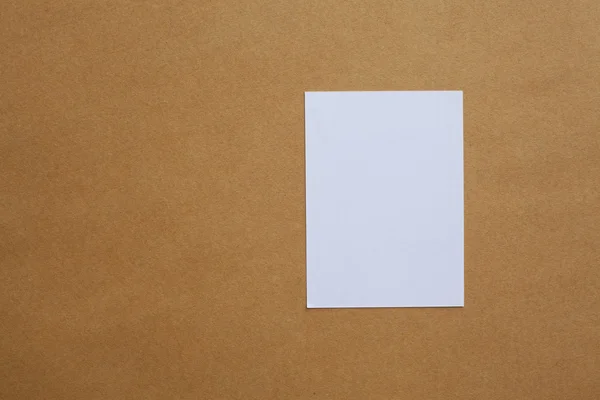 Stock image Blank White paper on Brown paper