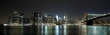 The New York City skyline w Brooklyn Bridge and Freedom tower clipart