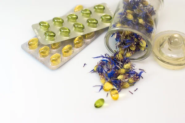 stock image Herbal capsules and dried herbs cornflower