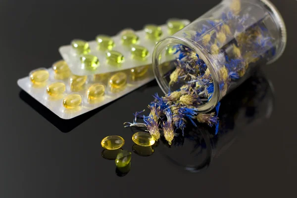 stock image Herbal capsules and dried herbs cornflower