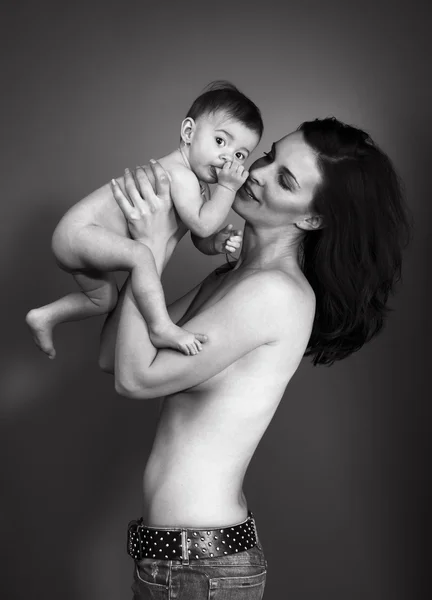 Madre cariñosa sosteniendo al bebé - toma de estudio —  Fotos de Stock