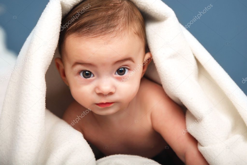 Adorable baby in white cover