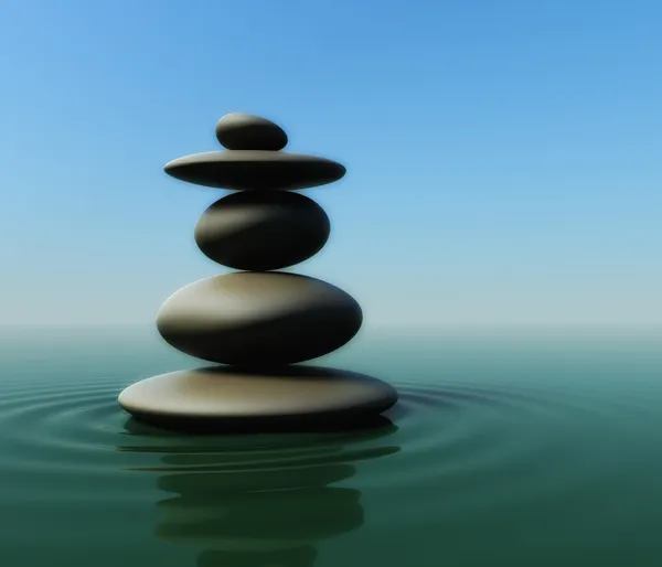 Balancing pebbles on water Stock Photo