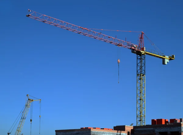 stock image Tower crane over the blue sky